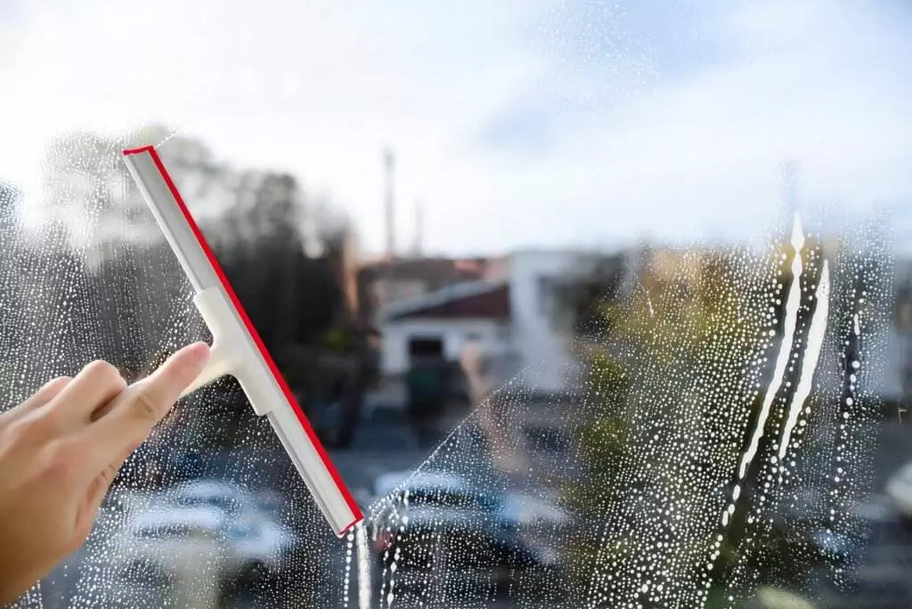 a guy providing professional window cleaning service