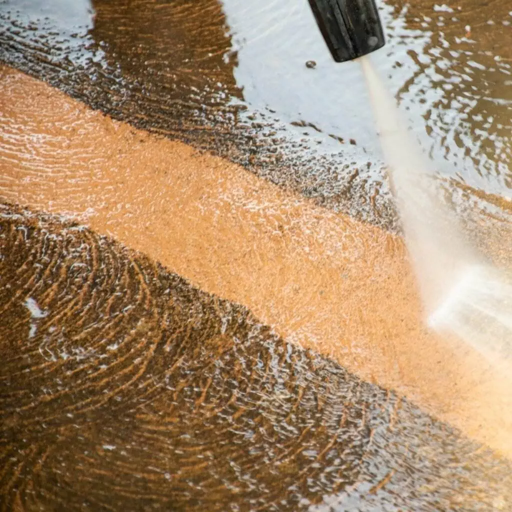 pressure washing services in los angeles page image of Washing dirty business outdoor tiles with high pressure cleaner.